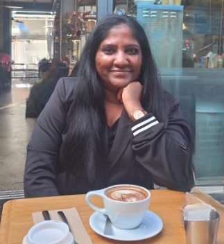 Lydia Govender sitting at a table with coffee